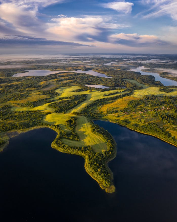 A breathtaking aerial shot of lush greenery and tranquil waterways under a clear sky, perfect for nature enthusiasts.